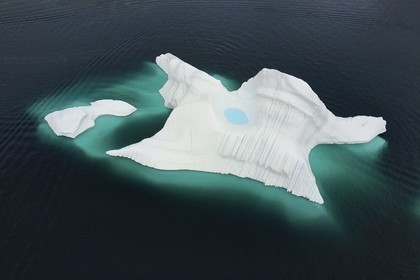 Greenland, west coast, Uummannaq fjord, iceberg with a small lake (aerial view)