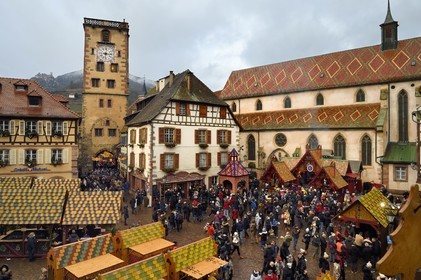 France, Haut Rhin, Strasbourg, Ribeauvillé, the medieval christmas market with in particular a stall offering wild boar on the square in front of the Augustinian convent church and the Tour des Bouchers (Butchers Tower)