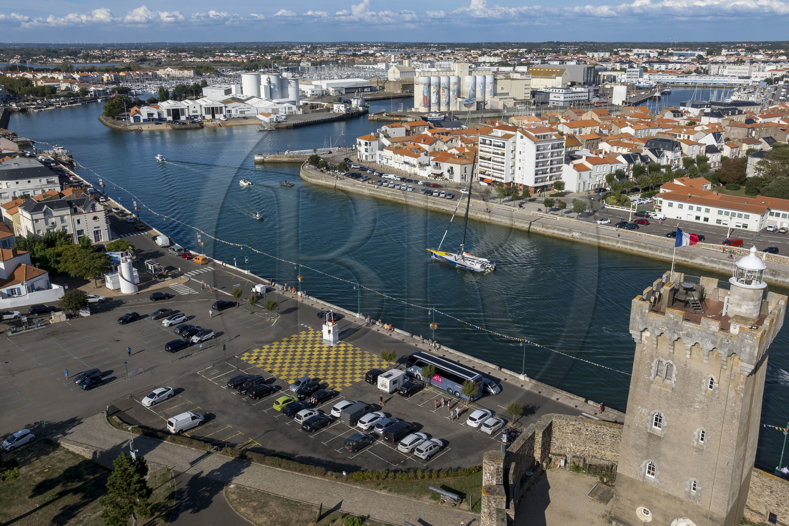 France, Vendee, Les Sables d'Olonne, boats in the access channel to the ports and the 14th century Arundel Tower, a former keep converted into a lighthouse and maritime museum (aerial view)