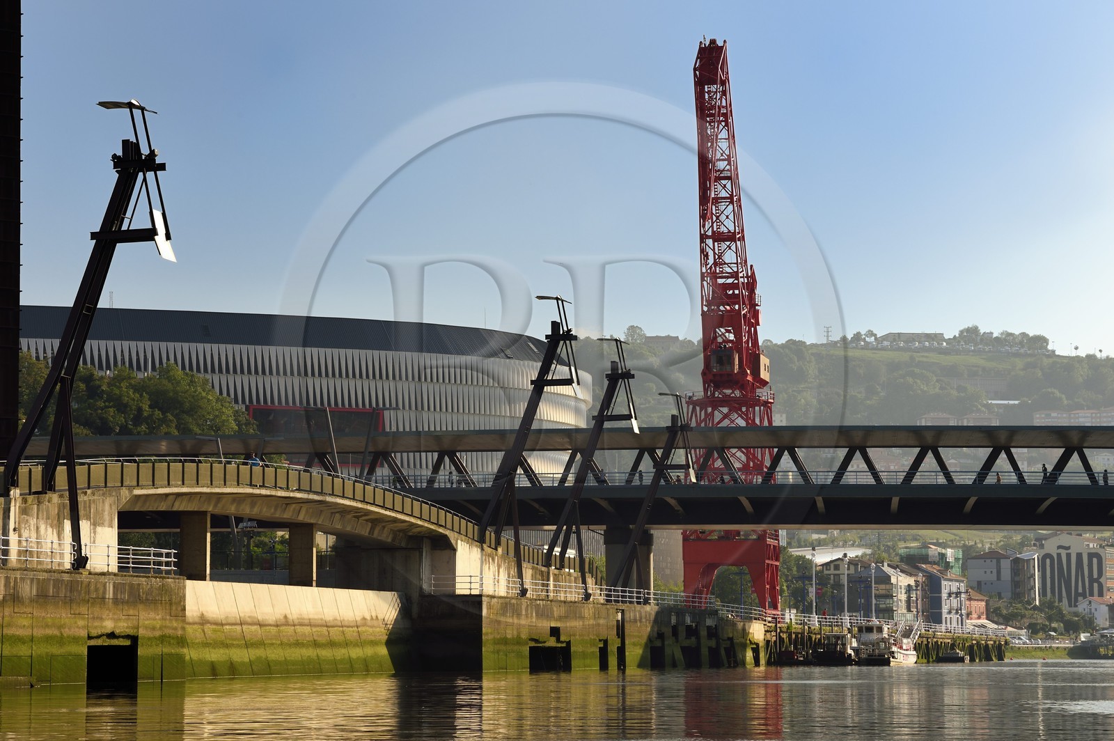 Spain, Basque Country, Biscay Province, Bilbao, the San Mamés Stadium (2013) by architect Norman Foster and the Carola crane next to the Ria de Bilbao