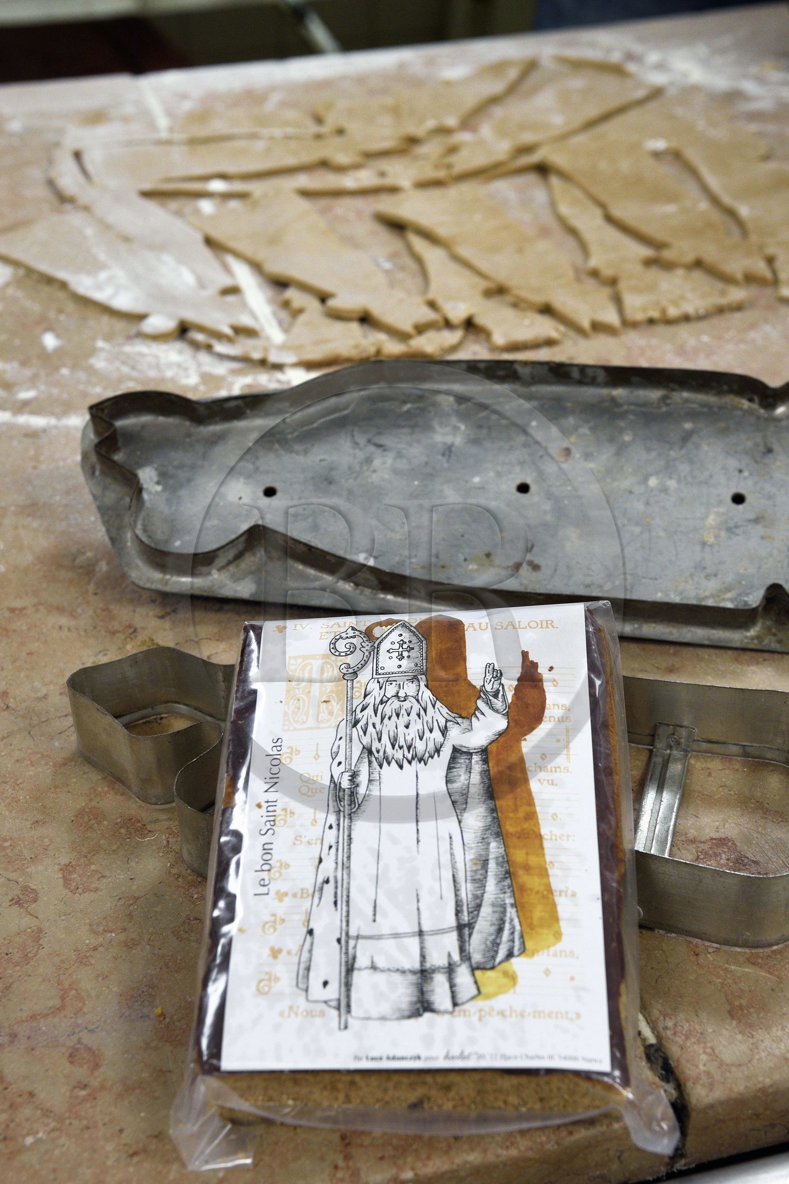 France, Meurthe-et-Moselle, Nancy, the pastry chef Didier Hulot making the gingerbread for Saint Nicholas Day, the dough is then cut by a cookie cutter having the silhouette of Saint-Nicolas, this one has been used for two generations