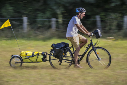 France, Maine-et-Loire, Loire valley listed as World Heritage by UNESCO, Saumur towards Saint-Hilaire, cycling on the banks of the Loire, bike with a trailer carrying camping equipment