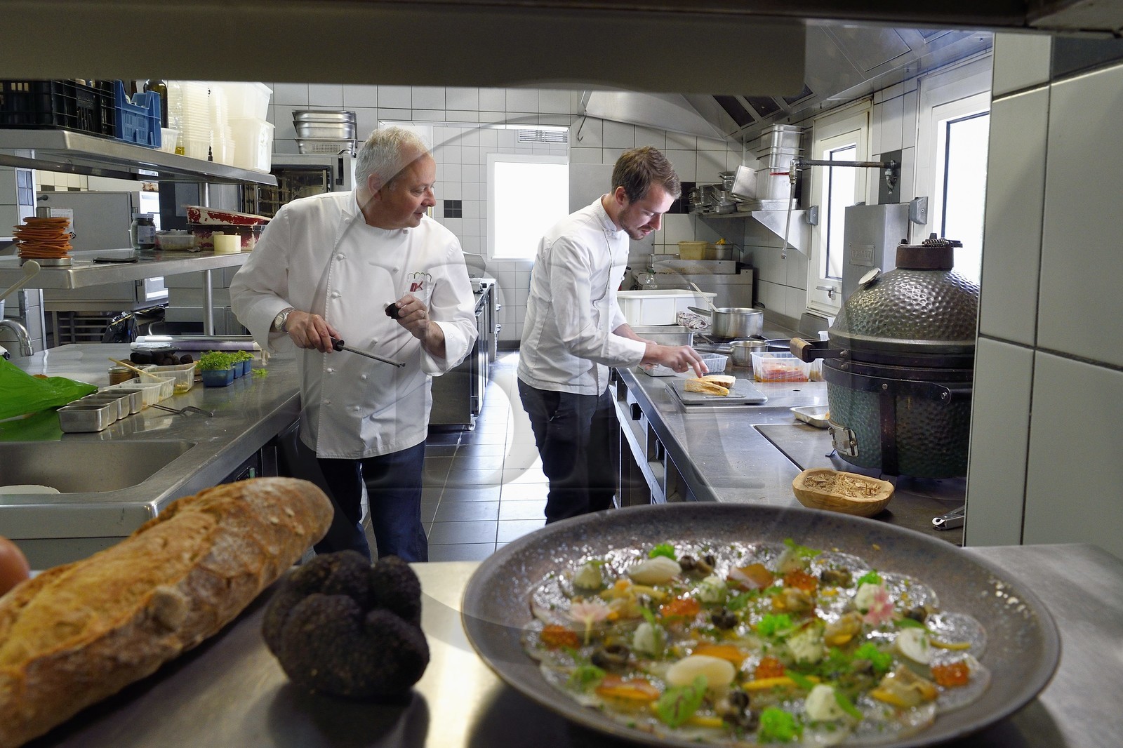 France, Charente, Bourg-Charente, restaurant La Ribaudière, Michelin-starred chef Thierry Verrat and his son Julien, preparation of the monkfish carpaccio and small shellfish in the foreground