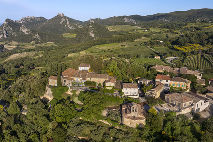 France, Vaucluse, Dentelles de Montmirail mountains, the village of Suzette surrounded by vineyards, the Clapis extended by the Grand Montmirail on the left, the Dentelles Sarrasines in the center and the Grand Travers on the right (aerial view)