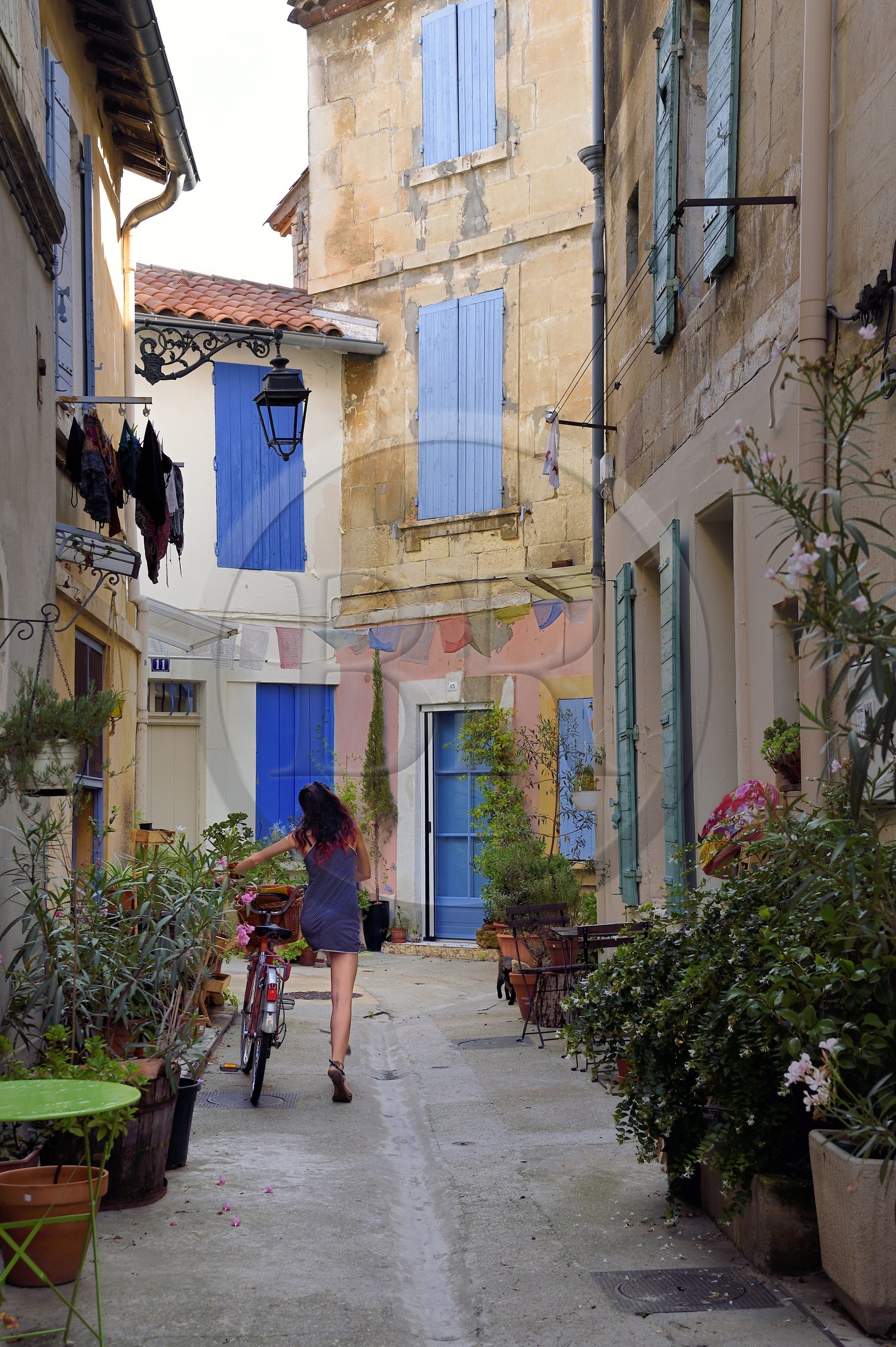 France, Bouches du Rhone, Arles, quartier de la Roquette, cyclist in the impasse Waldeck-Rousseau also called smile street