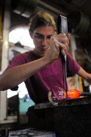 France, Moselle, Meisenthal, souffleur au Centre international d'Art verrier (CIAV), making of a christmas bowl made of glass, blowpipe put on a bench called «gamin mecanique», Thibault using his trade's cutters