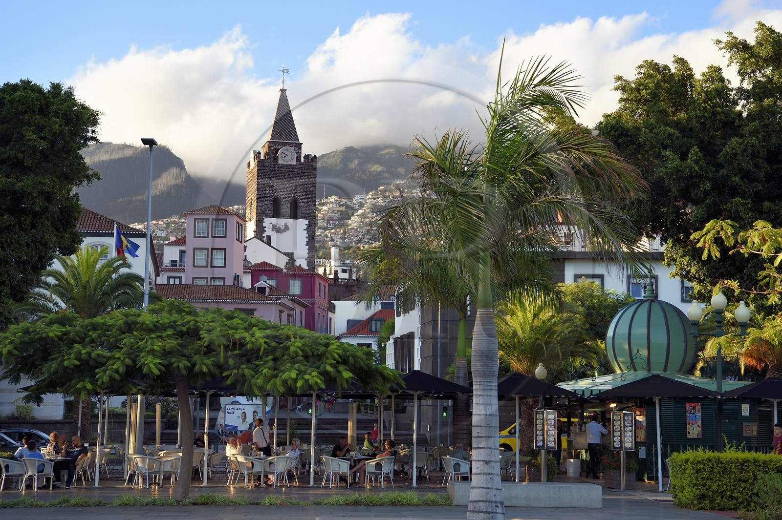 Portugal, Madeira Island, Funchal, cafe terrace on the seafront and the Our Lady of the Assumption Cathedral
