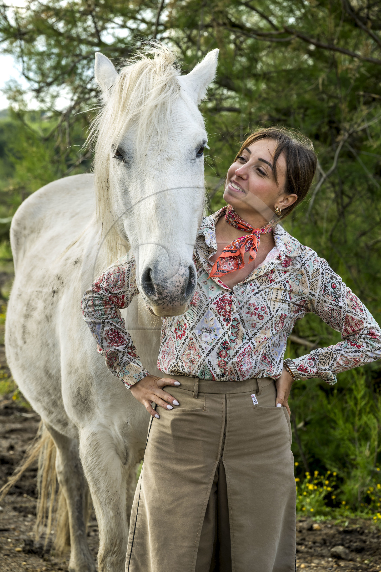 France, Gard, Saint Gilles du Gard, Pierre Aubanel & son manade (cattle and horses ranch), female volunteer gardian (cow-boy) Celia Boulaire with a Camargue horse