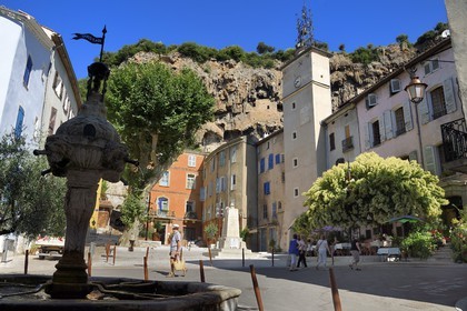 France, Var, Provence Verte, Cotignac, the Town Hall Square and the Clock tower below the tufa cliff of 80 meters high and 400 meters wide