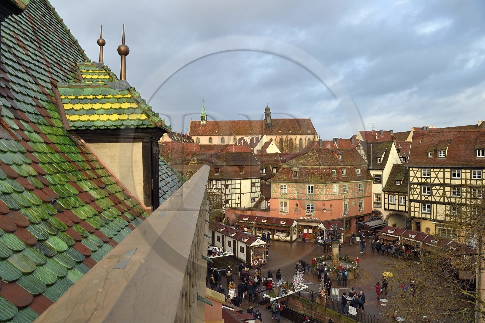France, Haut Rhin, Colmar, roof with glazed tiles of the former douane or customs control edifice (Koifhus) looking over the Christmas market on the Place de l'Ancienne Douane