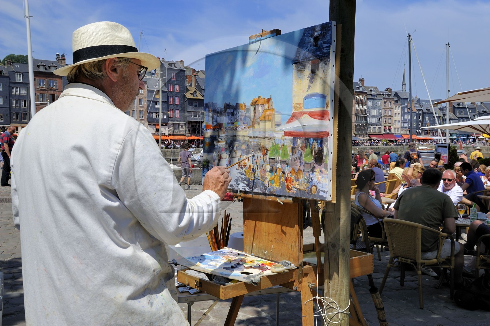 France, Calvados, Honfleur, the local painter Daniel Lallemand painting the Vieux-Bassin (Old Basin)