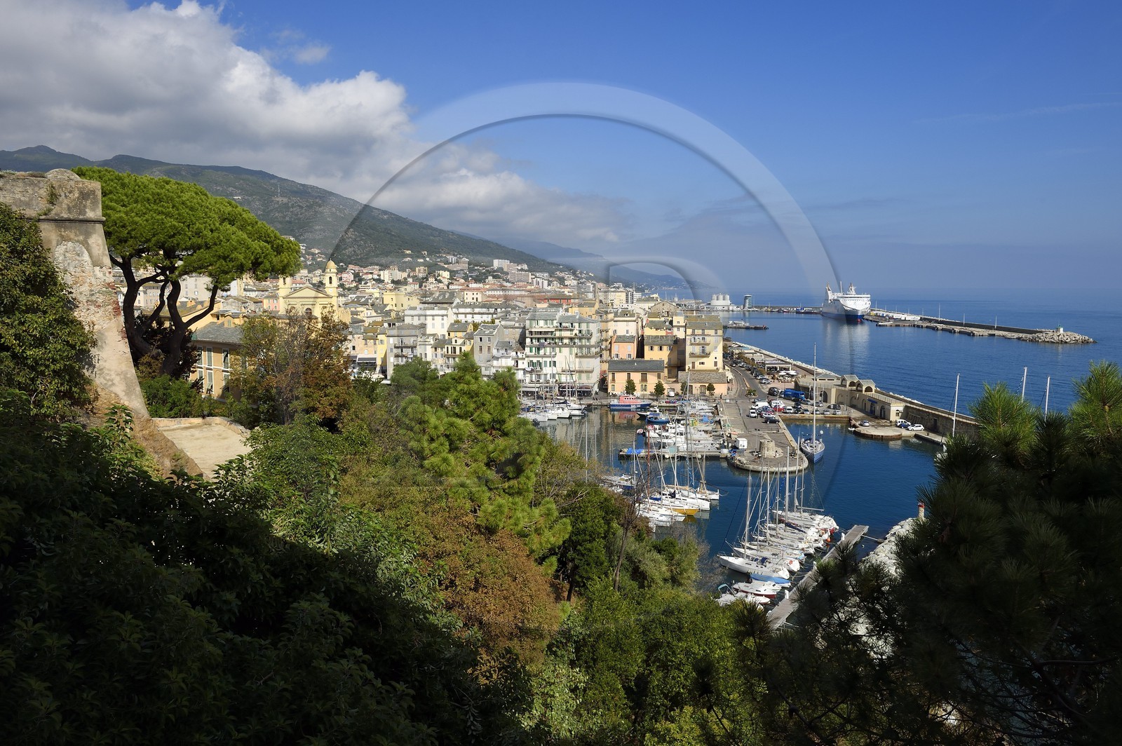 France, Haute Corse, Bastia, a tower from the Citadel left and the harbour overlooked by St Jean Baptiste Church on the right