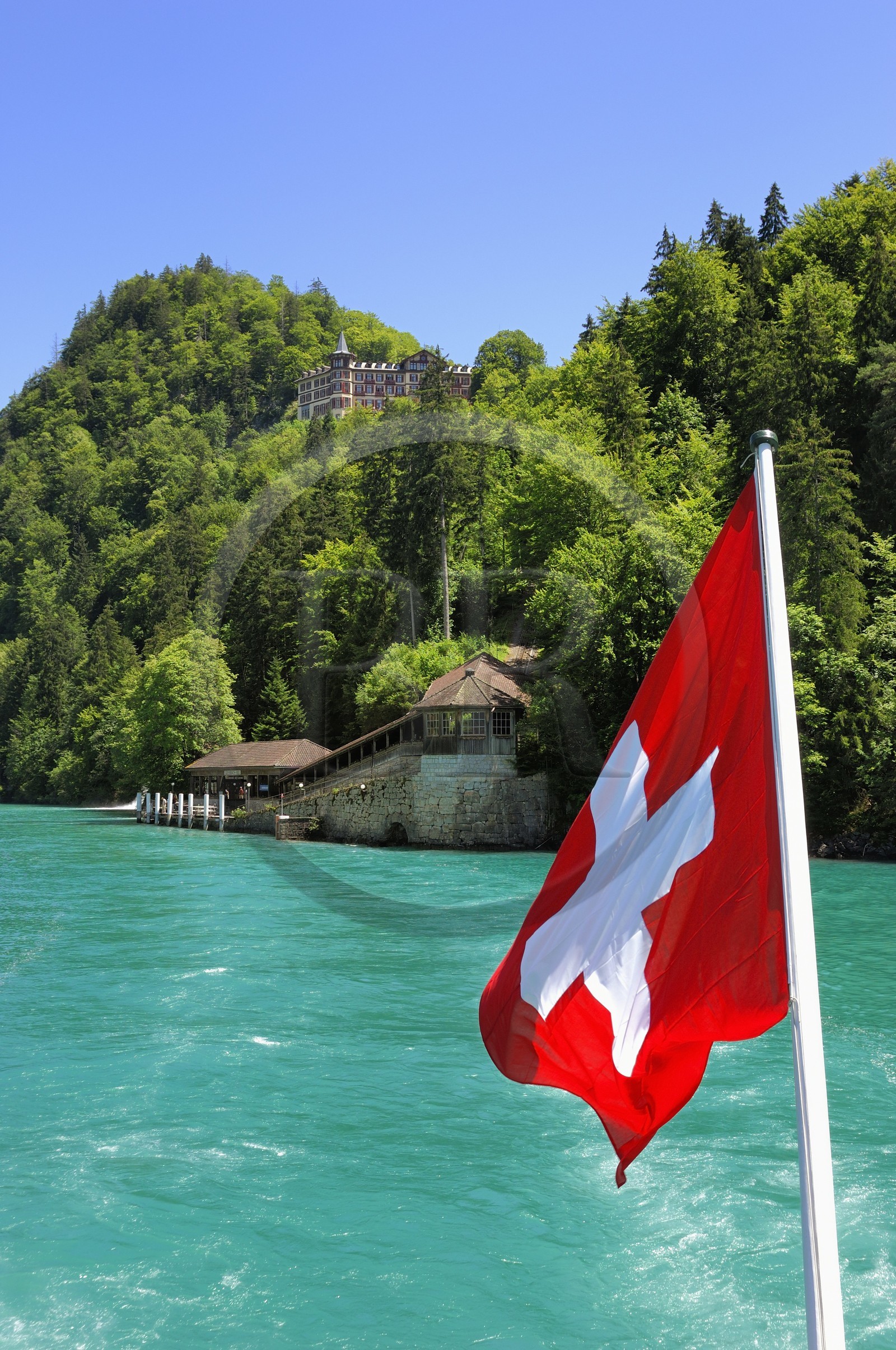 Switzerland, Canton of Bern, Bernese Oberland, Interlaken, Lake Brienz (Brienzer See), Luxury Hotel in Giessbach and swiss flag