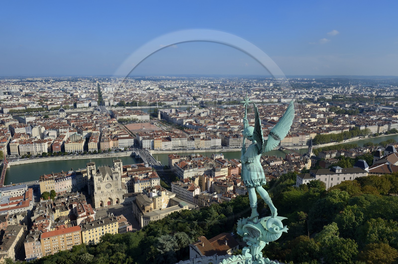 France, Rhone, Lyon, historical site listed as World Heritage by UNESCO, Vieux Lyon (Old Town), the statue of the Archangel Saint Michael slaying the dragon sculpted by Millefaut on the apse of the the Notre Dame de Fourviere Basilica in the foreground, Saint Jean Cathedral (Saint John's Cathedral) and the district of La Presqu'Ile in the background