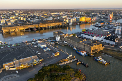 France, Loire Atlantique, Saint Nazaire, the former German submarine base built during the last world war border the dock of the harbour basin of Saint-Nazaire, the East lock and the fortified lock in the foreground on the right (aerial view)