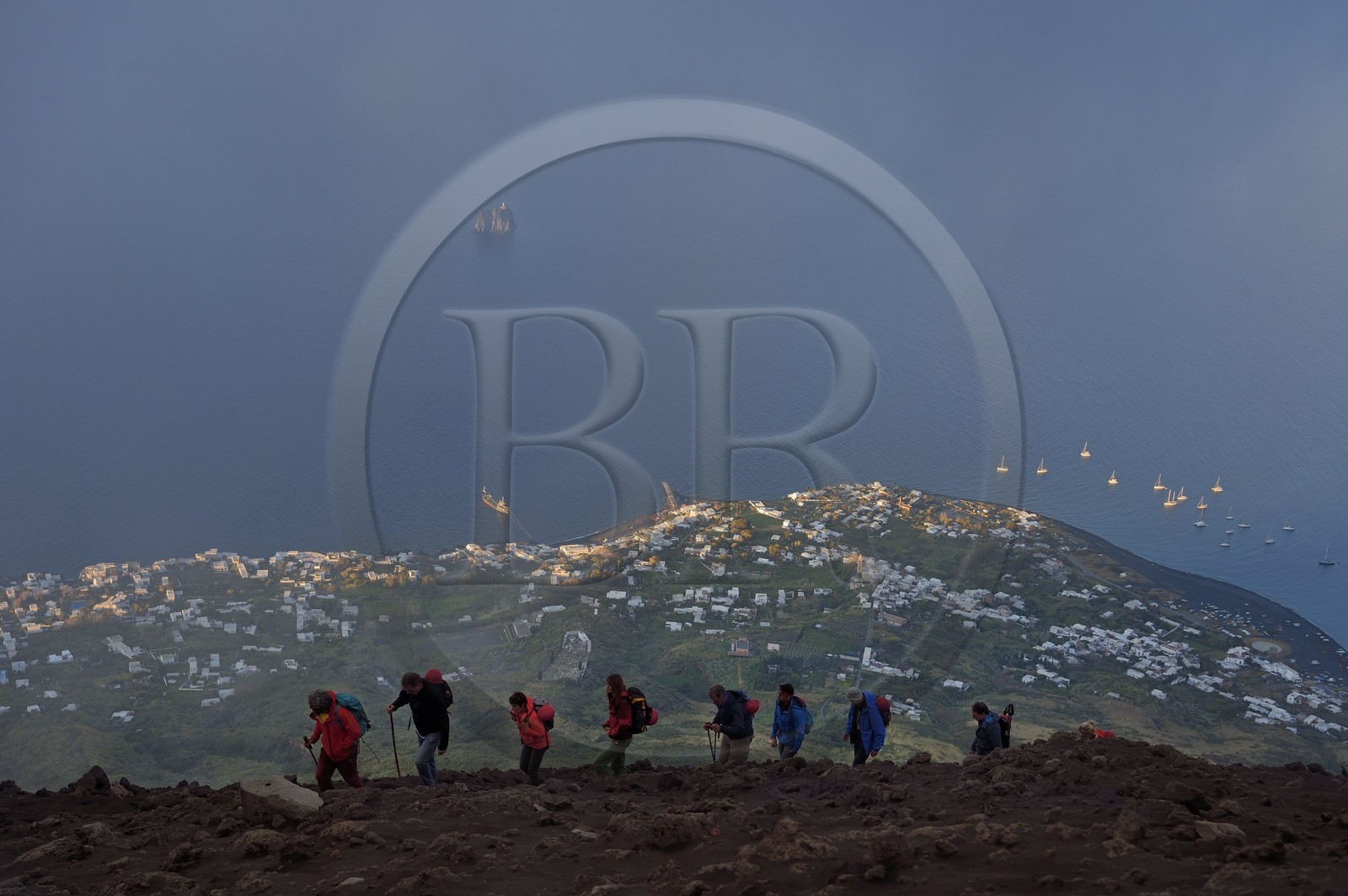 Italy, Sicily, Aeolian Islands, listed as World Heritage by UNESCO, Stromboli island, hikers climbing the volcano, the village of Stromboli and the islet of Strombolicchio in the background