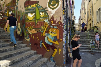France, Bouches du Rhone, Marseille, Panier district, corner of Sainte-Francoise and Repenties streets, graffiti from the Undartground concept store surrounded by stairs, work of street Brazilian artist Nhobi