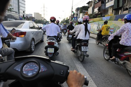 Vietnam, Hanoi, motorcycle traffic on Tran Quang Khai along the dike, fresco made for the Hanoi millenium