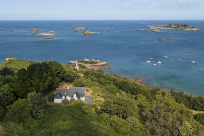 France, Cotes d'Armor, Ploubazlanec, chapel and Pointe de la Trinité, in the background the Island of Saint-Riom and the multiple rocks that surround it (aerial view)