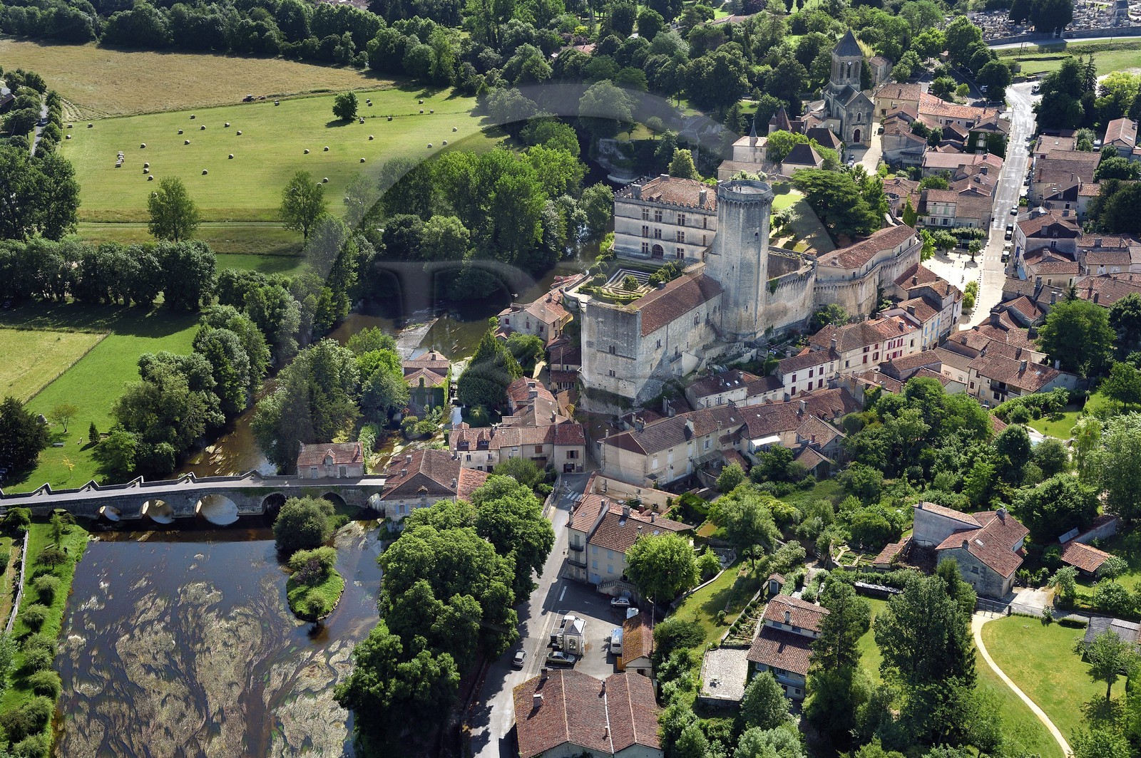France, Dordogne, Perigord Vert, Bourdeilles, the castle overlooking the village and the Dronne river (aerial view)