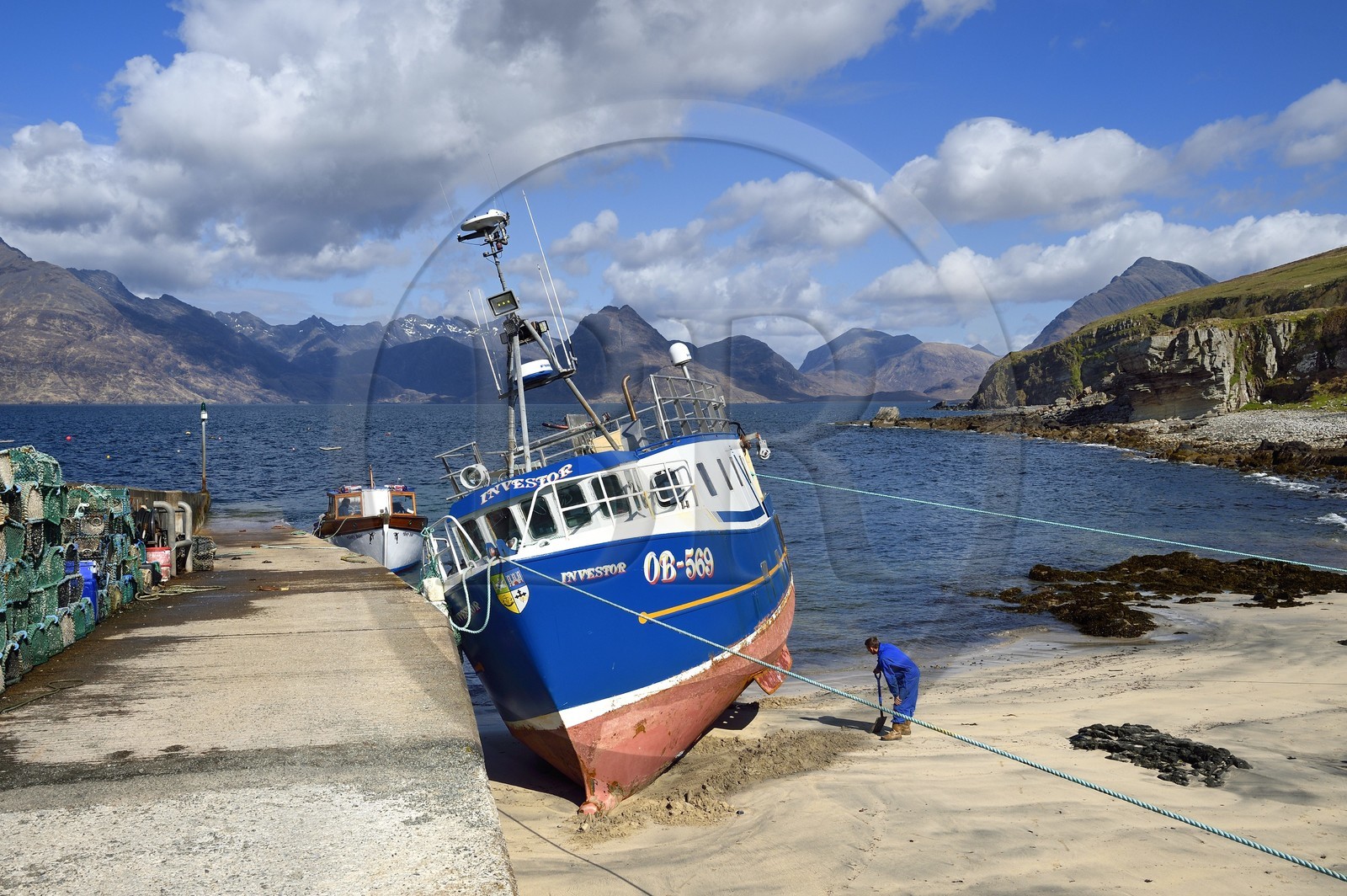 United Kingdom, Scotland, Highlands, Hebrides, Isle of Skye, fishing boat in the small port of the Elgol village on the shores of Loch Scavaig towards the end of the Strathaird peninsula and the Black Cuillin Mountains in the background