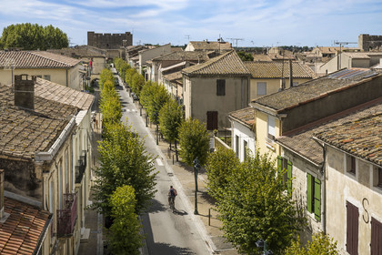 France, Gard, Aigues Mortes, Boulevard Gambetta in the old town from the ramparts and the Porte de la Marine Tower in the background