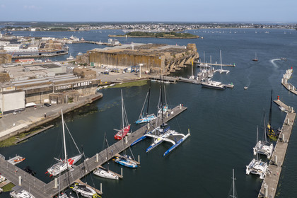 France, Morbihan, Lorient, the port of Lorient La Base in the former submarine base built by the Germans, it is designed and equipped to accommodate nautical professionals, nautical events and large units such as monohulls and multihulls of the Offshore racing, maxi-trimaran-hydrofoil sailboat Maxi Banque populaire XI of navigator Armel Le Cléac'h (aerial view)