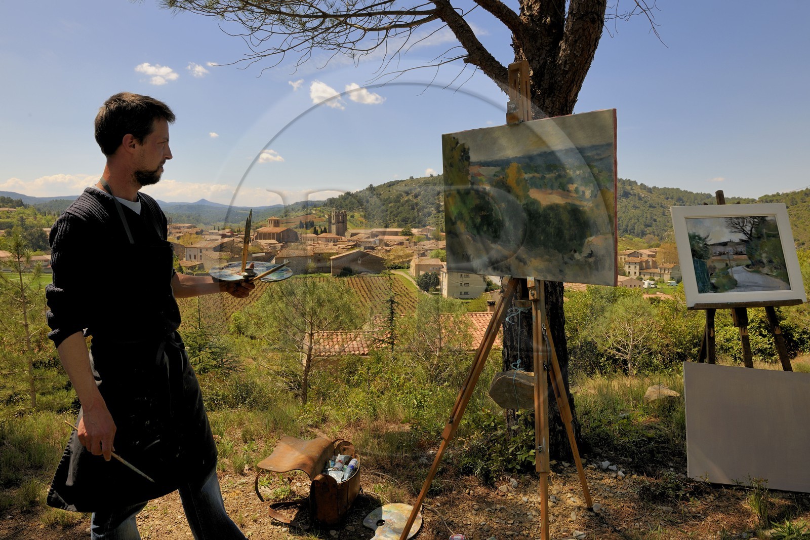 France, Aude, Lagrasse village, labelled Les Plus Beaux Villages de France (The Most Beautiful Villages of France), a painter in front of the village