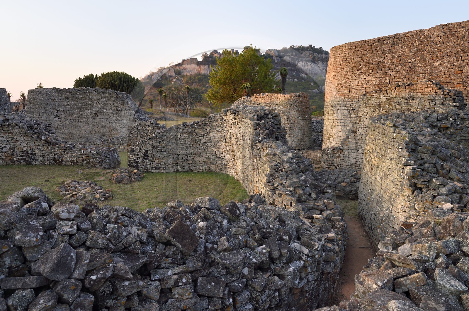 Zimbabwe, Masvingo province, the ruins of the archaeological site of Great Zimbabwe, UNESCO World Heritage List, 10th-15th century, exterior wall north-east entrance from inside of the Great Enclosure and the Hill Complex in the background