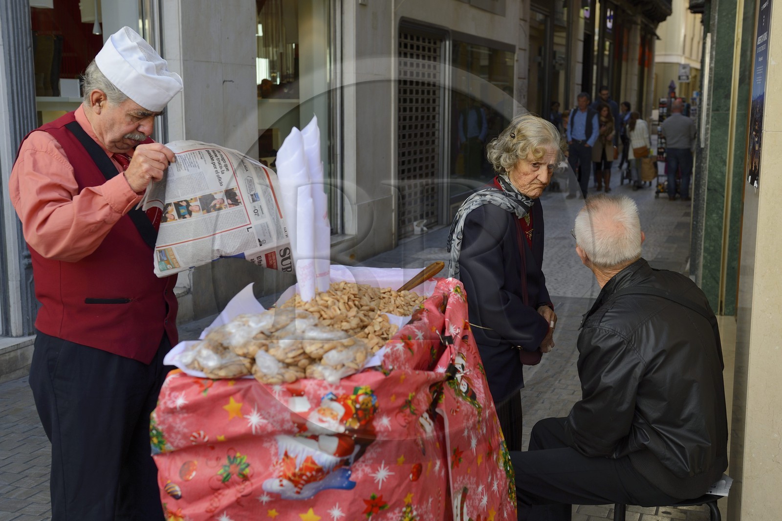 Spain, Andalusia, Malaga, almonds seller in the street