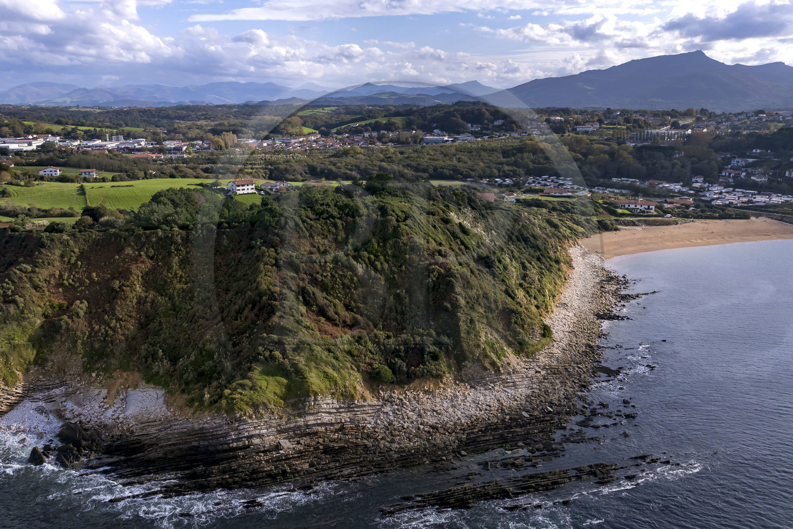 France, Pyrenees Atlantiques, Basque Country coast, Saint-Jean-de-Luz, coastal path on the GR 8, the cape overlooking Erromardie beach on the right and La Rhune mountain in the background (aerial view)