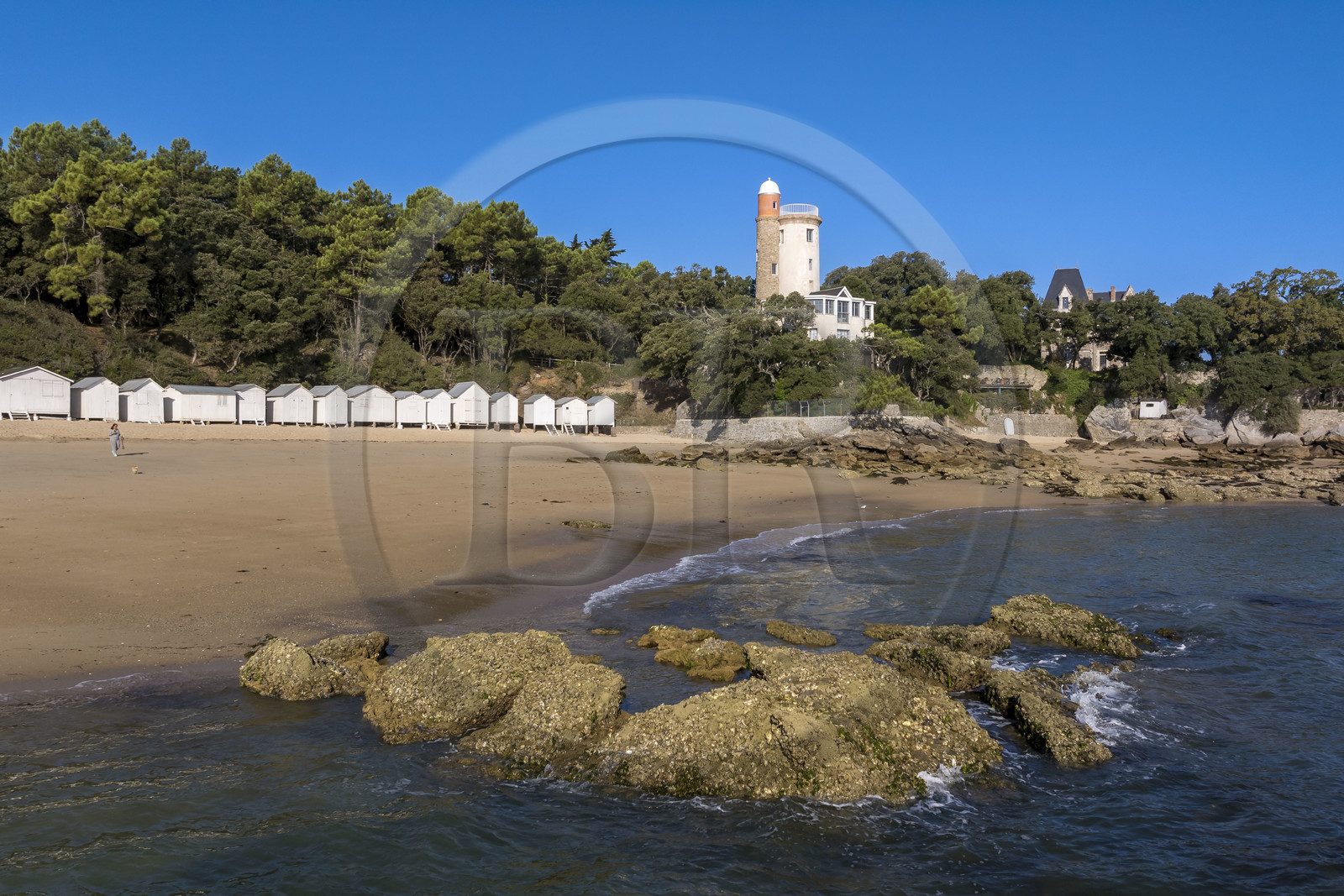 France, Vendée, Noirmoutier island, Noirmoutier en l’Ile, the Bois de la Chaise, Anse Rouge beach and its wooden beach huts, dominated by the Plantier Tower (aerial view)