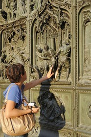 Italy, Lombardy, Milan, the Duomo in the historical center, cathedral in Gothic Flamboyant style, central portal, bronze door which tells the story of Mary's life (drawings by Ludovico Pogliaghi)