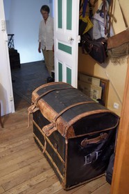 France, Alpes de Haute Provence, Ubaye valley, Jausiers, mexican villa known as Villa San Carlos, Sophie Meche-Fortoul look at the travel trunk of her grandfather Eugene Fortoul who emigrated to Mexico in the early twentieth century marked of his initials EF