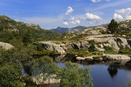 Norvège, Rogaland, région du Lysefjord, campeurs au bord d'un petit lac sur le chemin de randonnée menant au Rocher de La Chaire (Preikestolen)
