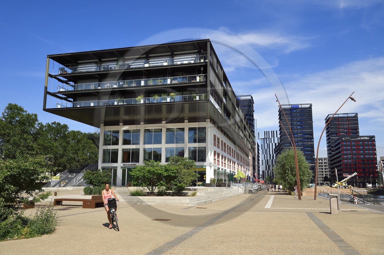 France, Bas Rhin, Strasbourg, development of port du Rhin (Rhine's harbour) and conversion of breakwater of Bassin d'Austerlitz, presqu'ile Malraux (Malraux peninsula), former Mole Seegmuller warehouse turned into commerce and residential flats, buildings the Black Swans by architect Anne Demians in the background