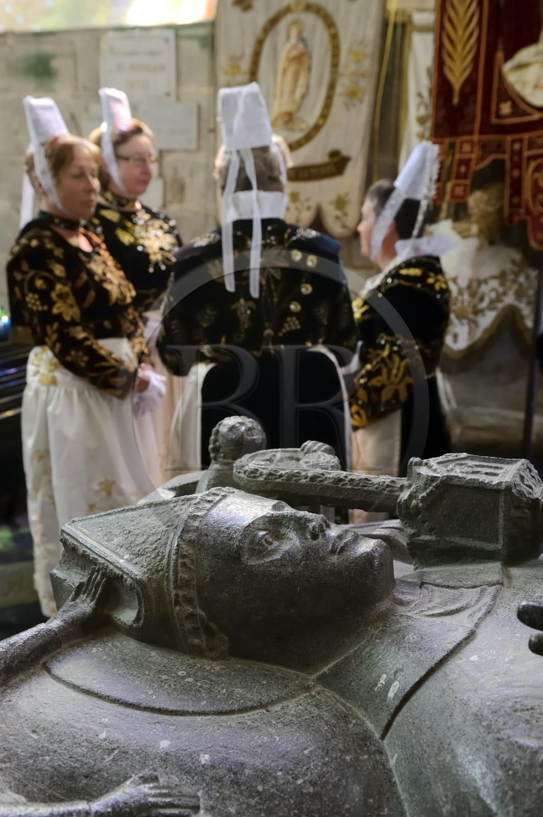 France, Finistere, Locronan, labelled Les plus Beaux Villages de France (The Most Beautiful Villages of France), women in traditional costume during the Tromenie around the cenotaph of St Ronan in Peniti chapel adjacent to the Saint Ronan church