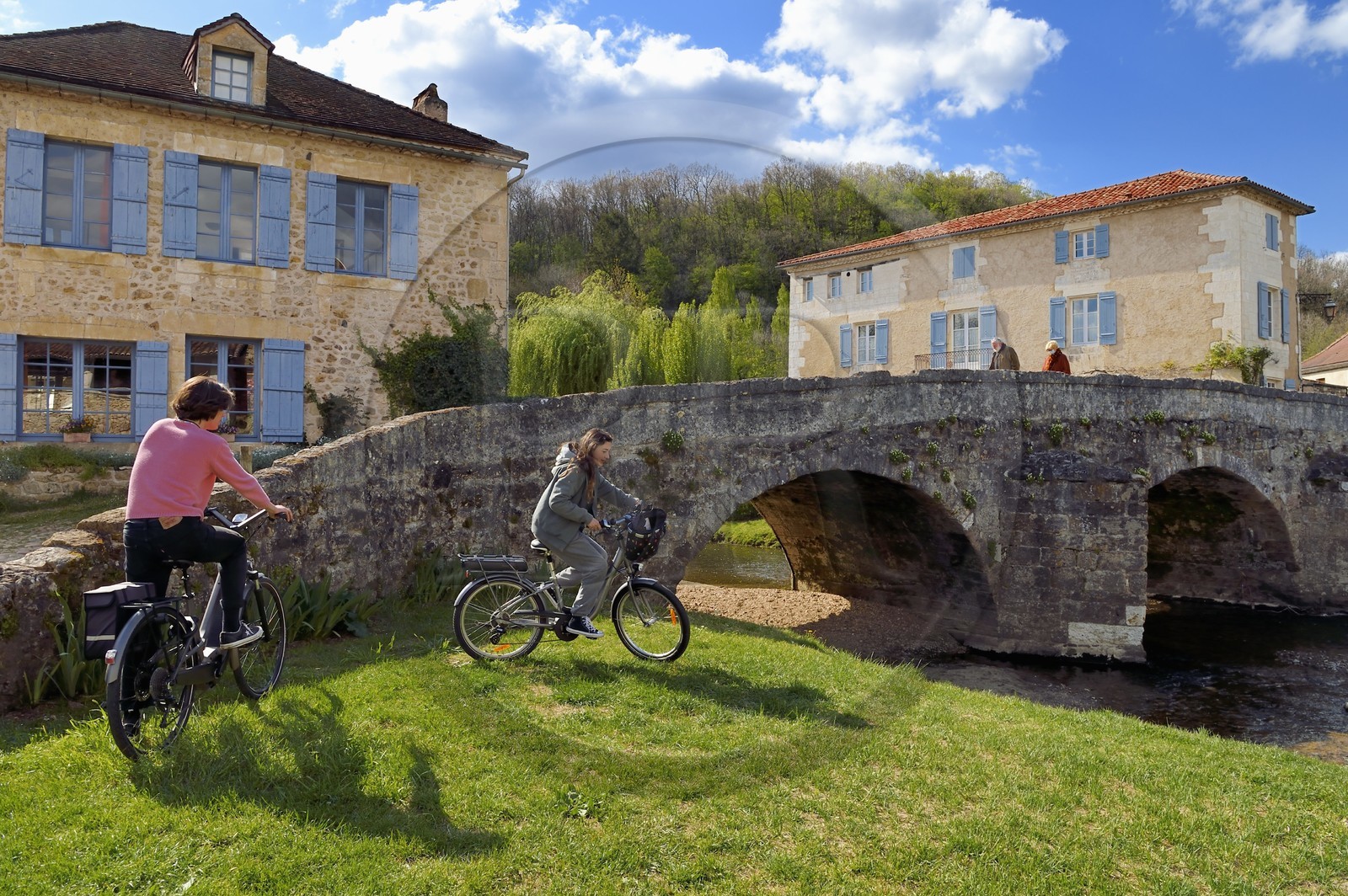 France, Dordogne, Périgord Vert, Saint Jean de Cole labelled Les Plus Beaux Villages de France (The Most Beautiful Villages of France), cyclists doing the Flow Vélo in front of the medieval bridge of the 12th century