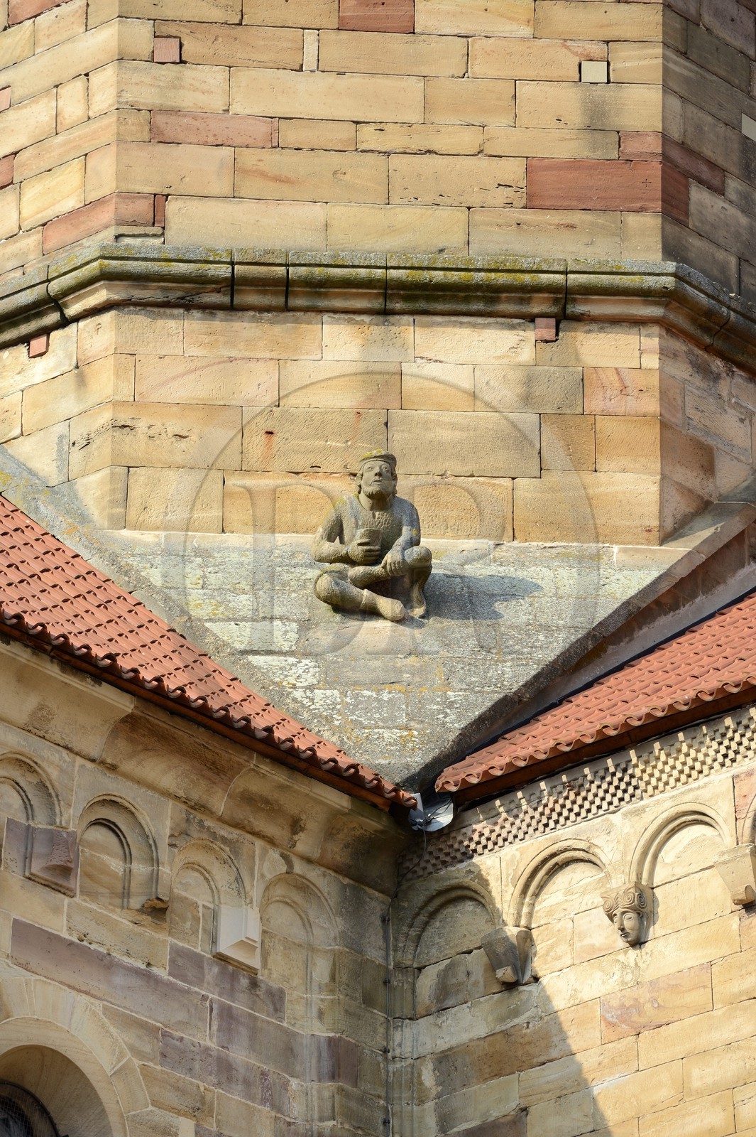 France, Bas Rhin, Rosheim village, St-Pierre and St-Paul roman Church, a seated man holding a begging bowl