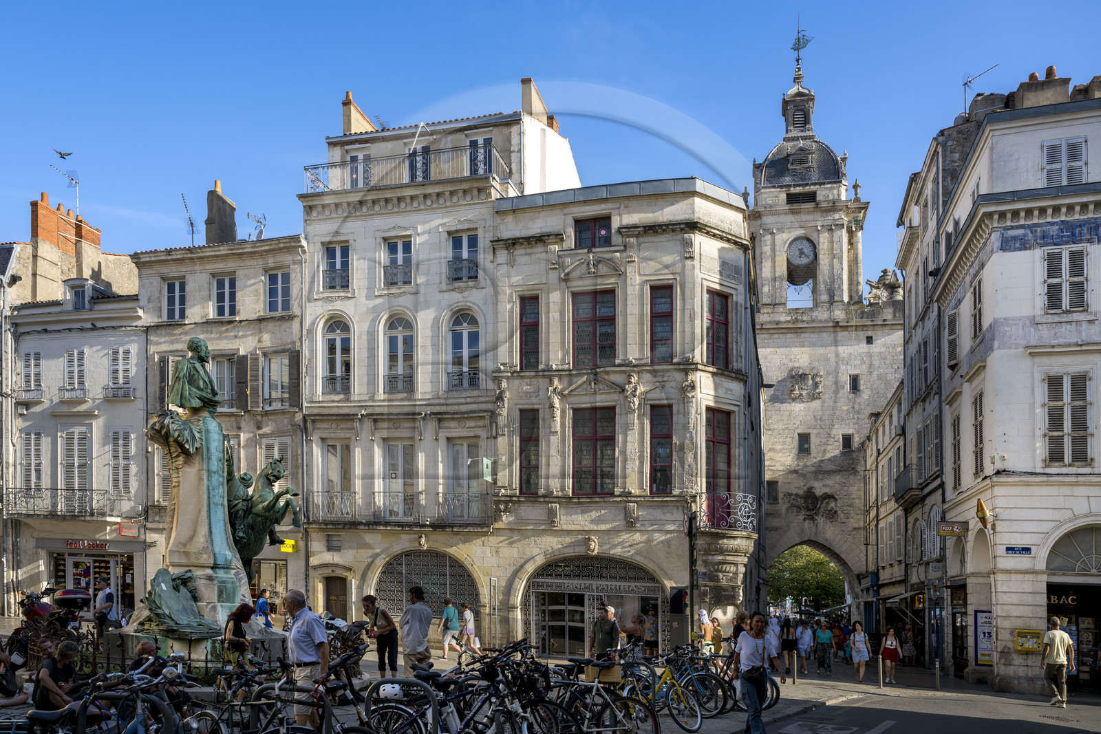 France, Charente Maritime, La Rochelle, Place des Petits Bancs, bronze bust of the orientalist painter and writer Eugène Fromentin (1820-1876) and equestrian statue of an Arab fantasia, group made in 1905 by the sculptor Ernest Dubois, the Great Clock Gate in the background