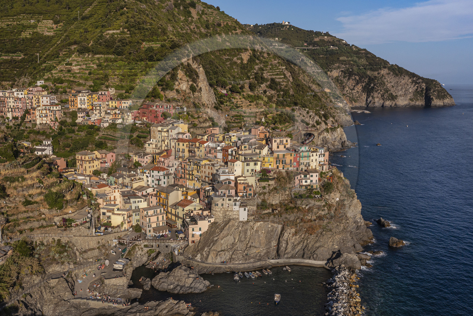 Italy, Liguria, Cinque Terre National Park listed as World Heritage by UNESCO, village of Manarola and its harbour (aerial view)