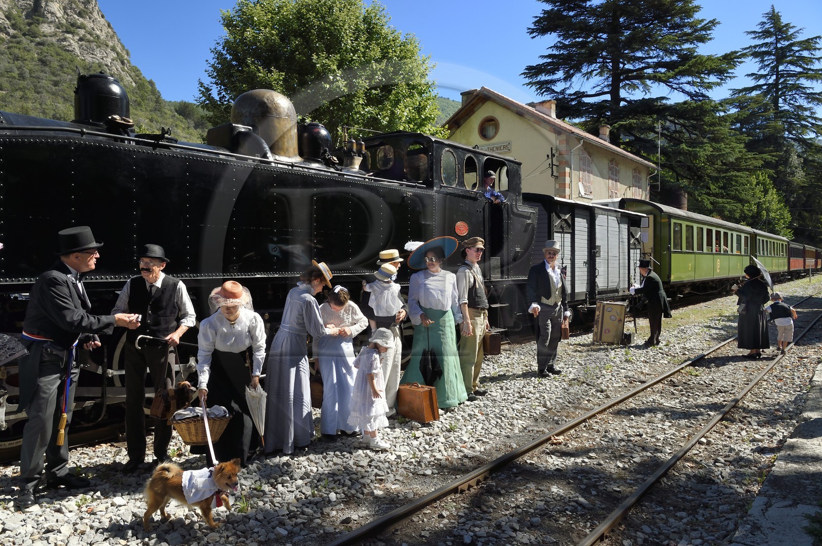 France, Alpes-Maritimes, Puget Theniers, the Train des Pignes historic train, members of the AHVAE (Association d'histoire vivante et de d'archeologie expérimentale) in Belle Epoque costume in front of the steam engine