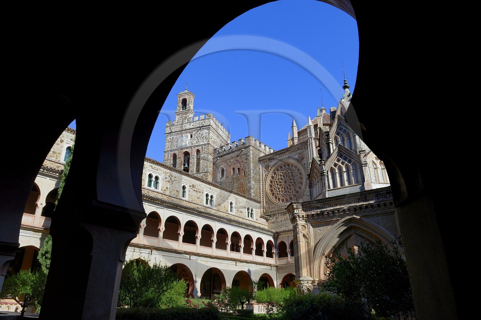 Spain, Extremadura, Guadalupe, Royal Monastery of Santa Maria de Guadalupe listed as World Heritage by UNESCO, Mudejar cloister built in the 15th century and the church in the background