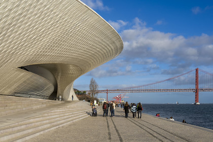 Portugal, Lisbon, Belem district, MAAT (Museum of Art, Architecture and Technology or Museu de Arte, Arquitetura e Tecnologia) on the banks of the Tagus, inaugurated in 2016 and designed by British architect Amanda Levete, the Ponte 25 de Abril bridge in the background