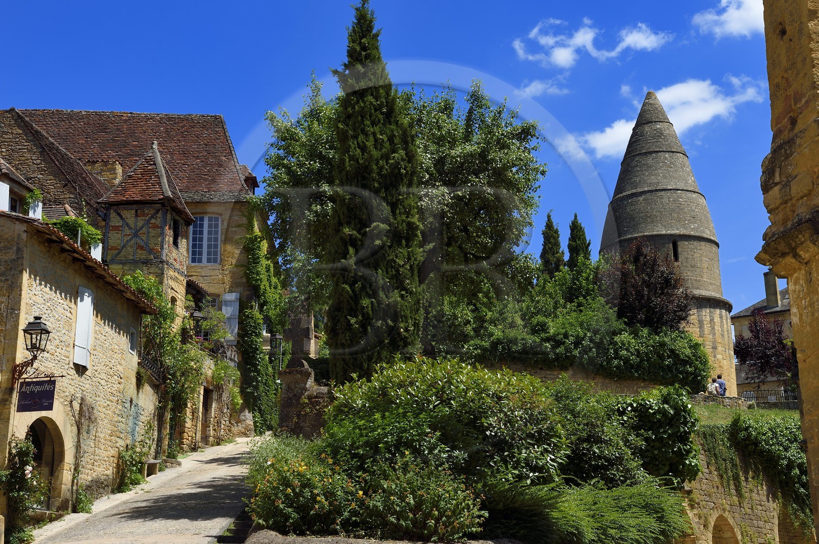 France, Dordogne, Perigord Noir, Dordogne valley, Sarlat la Caneda, old pigeon house in the Rue Montaigne left and the Lantern of the Dead (12th century) of almost 10 m high