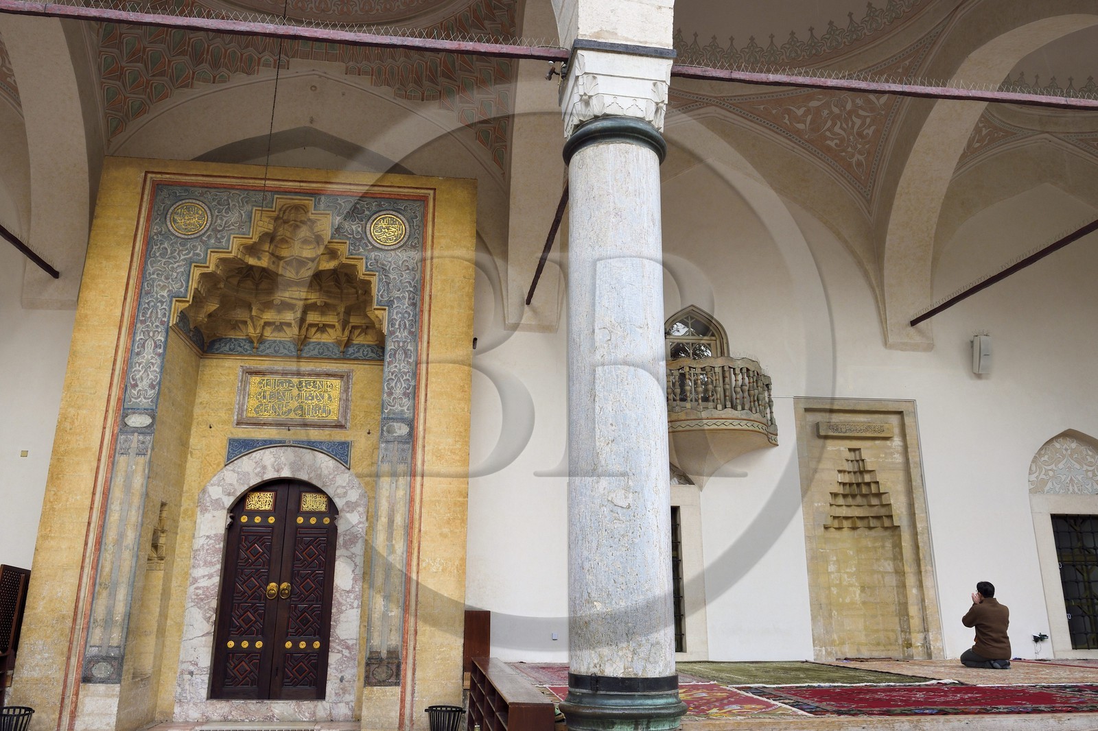 Bosnia and Herzegovina, Sarajevo, Bascarsija district in the old town, man praying outside the Gazi Husrev-bey Mosque (Gazi Husrev-begova Dzamija in bosnian)