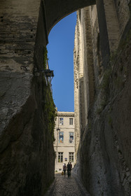 France, Vaucluse, Avignon, the rue de la Peyrolerie, a passage dug into the rock at the foot of the Palais des Papes (Palace of the Popes) classified as UNESCO World Heritage