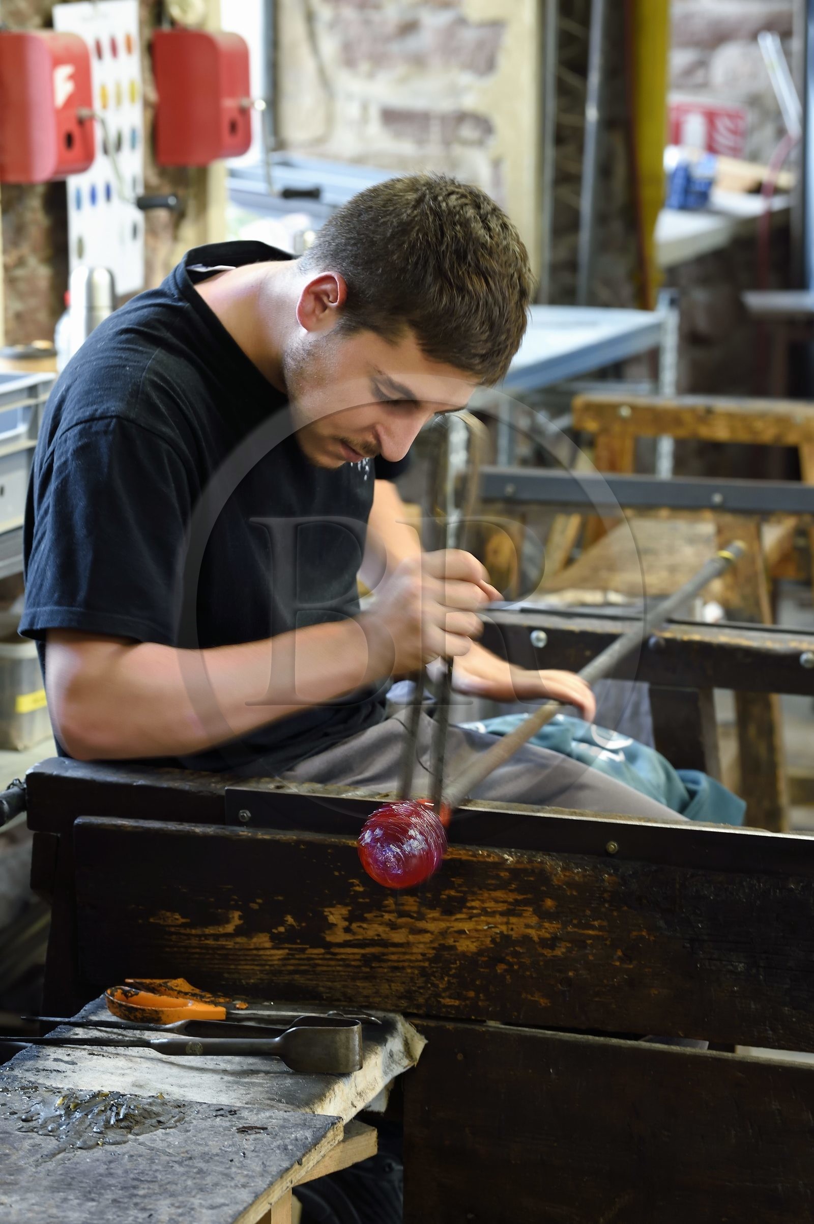France, Moselle, Meisenthal, Centre international d'Art verrier (CIAV) (international glass centre), the blowing workshop, crafting a Christmas ball, shaping at the outlet of the blow mold