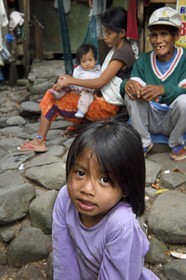 Philippines, Ifugao province, Banaue region, village of Cambulo, little girl in front of the family home