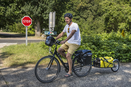 France, Maine-et-Loire, Loire valley listed as World Heritage by UNESCO, Saumur towards Saint-Hilaire, cycling along the banks of the Loire on the Loire à Vélo cycle path, bike with a trailer carrying camping equipment